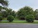 Well-manicured landscaping featuring ornamental trees and shrubs along a street in a residential community at 15424 Sweet Orange Ave, Winter Garden, FL 34787