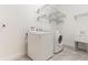Bright laundry room features washer, dryer, and convenient wire shelving at 15424 Sweet Orange Ave, Winter Garden, FL 34787
