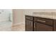 Laundry room has granite countertop on wood cabinets with a view to the washer/dryer at 15424 Sweet Orange Ave, Winter Garden, FL 34787