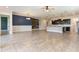 Spacious living room with tile flooring, modern lighting, and accent wall at 15424 Sweet Orange Ave, Winter Garden, FL 34787