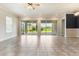 Bright living room with tile floors, sliding glass doors leading to the outdoor living space at 15424 Sweet Orange Ave, Winter Garden, FL 34787