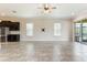 Bright living room with tile floors, ceiling fan, and access to the outdoor patio at 15424 Sweet Orange Ave, Winter Garden, FL 34787