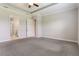 Spacious primary bedroom with tray ceilings and carpet flooring, leading to an ensuite bathroom at 15424 Sweet Orange Ave, Winter Garden, FL 34787