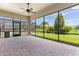 Screened patio features brick pavers and an outdoor ceiling fan at 15424 Sweet Orange Ave, Winter Garden, FL 34787
