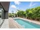 Modern backyard pool with bamboo surround and wood decking next to backyard with modern home at 1742 Temple Dr, Winter Park, FL 32789