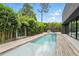 Modern backyard pool with bamboo surround and wood decking next to backyard at 1742 Temple Dr, Winter Park, FL 32789