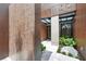 Modern home entryway with unique metal facade and natural landscaping at 1742 Temple Dr, Winter Park, FL 32789