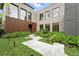 Beautiful front yard with lush landscaping, stone pathway, and modern home exterior at 1742 Temple Dr, Winter Park, FL 32789