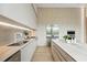 Bright kitchen featuring modern appliances, a sleek countertop, and light wood cabinetry at 1742 Temple Dr, Winter Park, FL 32789