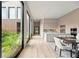 Sunlit open-concept kitchen with modern appliances and dining area overlooking a bright outdoor courtyard at 1742 Temple Dr, Winter Park, FL 32789