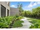 Beautiful front yard with lush landscaping, stone pathway, and modern home exterior at 1742 Temple Dr, Winter Park, FL 32789