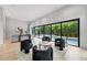 Large living room with hardwood floors, modern furniture, large windows and view of pool with bamboo at 1742 Temple Dr, Winter Park, FL 32789