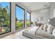 Bright main bedroom features large windows with natural light, light wood floors, and modern aesthetic at 1742 Temple Dr, Winter Park, FL 32789