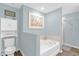 Relaxing bathroom with a soaking tub, separate shower, and elegant fixtures at 17485 Sw 36Th Ter, Ocala, FL 34473