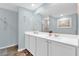 Well-lit bathroom featuring double sinks, a large mirror, and modern finishes at 17485 Sw 36Th Ter, Ocala, FL 34473