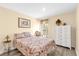 Cozy bedroom with a floral-patterned bed, wood-look flooring, and plenty of natural light at 17485 Sw 36Th Ter, Ocala, FL 34473