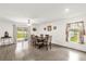 Dining area with wood-look floors, a large dining table, and sliding glass doors to the backyard at 17485 Sw 36Th Ter, Ocala, FL 34473