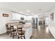 Modern kitchen with white cabinets, stainless steel appliances, granite counters, and a breakfast bar with stools at 17485 Sw 36Th Ter, Ocala, FL 34473