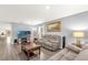 Cozy living room featuring plush seating, a large TV, and wood-look floors for a modern aesthetic at 17485 Sw 36Th Ter, Ocala, FL 34473