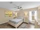 Serene main bedroom with neutral tones, ceiling fan, wood-look floors, and natural light at 17485 Sw 36Th Ter, Ocala, FL 34473