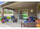 Comfortable covered patio with stylish seating offers relaxation with a peaceful backyard view at 17485 Sw 36Th Ter, Ocala, FL 34473