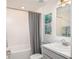 Clean bathroom with white subway tile, gray vanity and blue accents at 214 Oak Lane Rd, Ocala, FL 34472