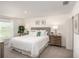 Bright main bedroom features neutral decor, a large window, and stylish wooden furniture at 214 Oak Lane Rd, Ocala, FL 34472