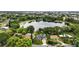 Breathtaking aerial view showcasing homes nestled around a tranquil lake, surrounded by verdant trees and cityscape at 2154 Lake Christie Dr, Orlando, FL 32809