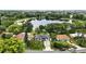 This aerial view showcases the home's proximity to a serene lake and lush greenery at 2154 Lake Christie Dr, Orlando, FL 32809