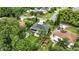 Aerial view showcases the backyard, solar panels, green lawn, privacy fence and surrounding neighborhood at 2154 Lake Christie Dr, Orlando, FL 32809