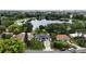 Beautiful aerial view of home with solar panels, pond, and lush landscaping at 2154 Lake Christie Dr, Orlando, FL 32809