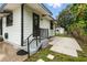 Back entrance boasts steps to the door and a quaint patio space, perfect for relaxing or enjoying an outdoor meal at 2154 Lake Christie Dr, Orlando, FL 32809