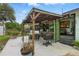 Outdoor patio features a covered seating area, grill, and dining space, perfect for entertaining and backyard barbecues at 2154 Lake Christie Dr, Orlando, FL 32809