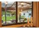 View through the window showcasing the backyard's covered porch, pond, and shed at 2154 Lake Christie Dr, Orlando, FL 32809