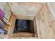 Basement entrance with wooden steps, hardwood floors and a wooden door at 2154 Lake Christie Dr, Orlando, FL 32809