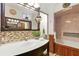 Bathroom featuring glass sink basin, and stylish wood paneling and mirror with decorative mosaic tile backsplash at 2154 Lake Christie Dr, Orlando, FL 32809