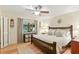 Comfortable bedroom featuring a ceiling fan, wood floors, and a bright window with a backyard view at 2154 Lake Christie Dr, Orlando, FL 32809