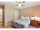 Bedroom with hardwood floors, ceiling fan, comfortable bed, and a nightstand with a lamp, creating a cozy space at 2154 Lake Christie Dr, Orlando, FL 32809