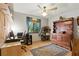 Bedroom with ceiling fan, hardwood floors, workspace and traditional wood dresser, offering comfort and functionality at 2154 Lake Christie Dr, Orlando, FL 32809