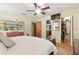 Bedroom featuring a TV, ceiling fan, closet, and views into the kitchen and backyard at 2154 Lake Christie Dr, Orlando, FL 32809
