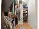 Walk-in closet featuring hanging clothes and wire shelving for storage at 2154 Lake Christie Dr, Orlando, FL 32809
