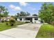 This inviting home with solar panels features a well-maintained lawn and a welcoming entrance at 2154 Lake Christie Dr, Orlando, FL 32809