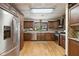 Well-equipped kitchen with stainless steel appliances, wood cabinets, and hardwood floors at 2154 Lake Christie Dr, Orlando, FL 32809