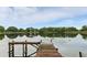 Picturesque lake view featuring a wooden dock, tranquil water, and lush greenery, perfect for relaxation and nature enthusiasts at 2154 Lake Christie Dr, Orlando, FL 32809