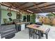 Spacious covered patio with an outdoor kitchen, dining area, and grill, great for entertaining guests outdoors at 2154 Lake Christie Dr, Orlando, FL 32809