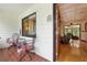 Charming front porch with patterned tile floor, cozy seating and a glimpse into the living room at 2154 Lake Christie Dr, Orlando, FL 32809