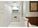 Luxurious shower featuring white tile, wood paneling, glass door, and seating at 2154 Lake Christie Dr, Orlando, FL 32809