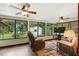 Relaxing sun room features ceiling fans and views of the yard and lake at 2154 Lake Christie Dr, Orlando, FL 32809