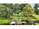 Stunning water view from the property featuring a wooden dock, lush greenery, and serene surroundings, ideal for relaxation at 2154 Lake Christie Dr, Orlando, FL 32809