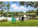 Scenic lake view featuring a wooden dock, chairs, and surrounding lush greenery, perfect for peaceful relaxation at 2154 Lake Christie Dr, Orlando, FL 32809